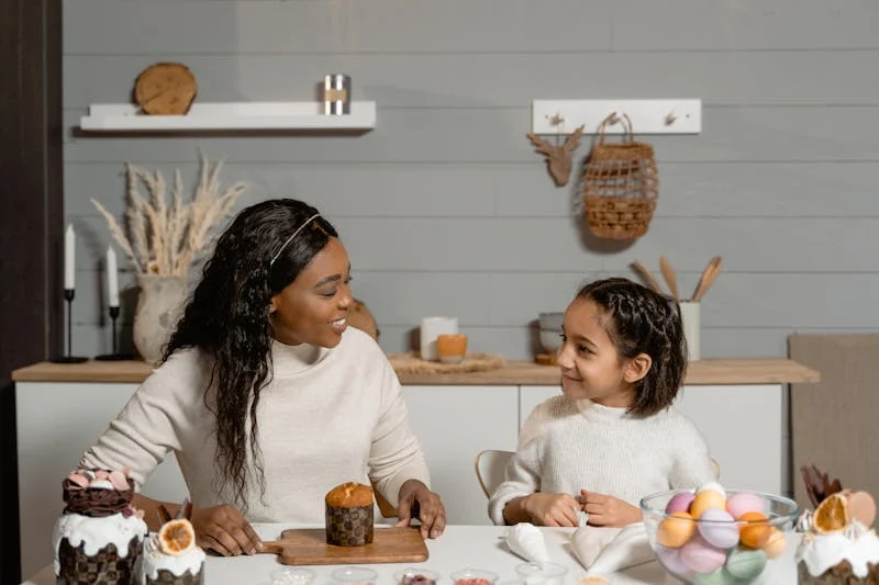 Mother and daughter sitting together at a table, sharing a meaningful conversation while preparing food, illustrating a moment of bonding and open communication