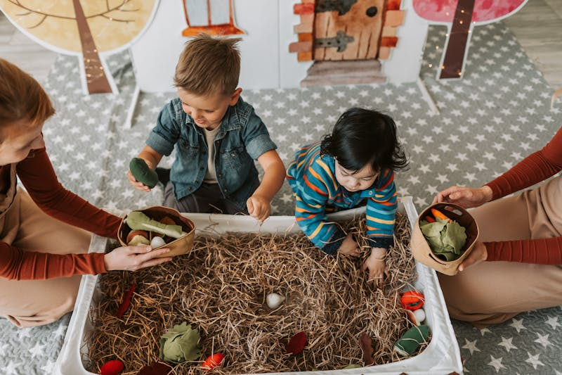 Children playing with sensory toys alongside adults, promoting screen-free activities and creative play.